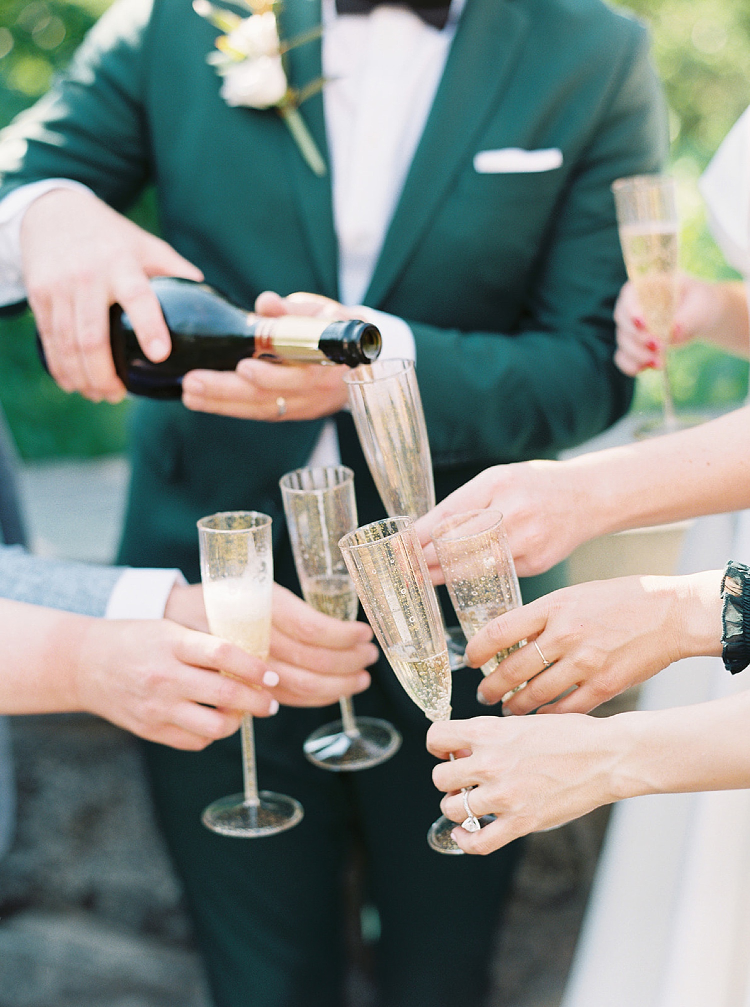 bride and groom share champagne with their guests during Central Park elopement 