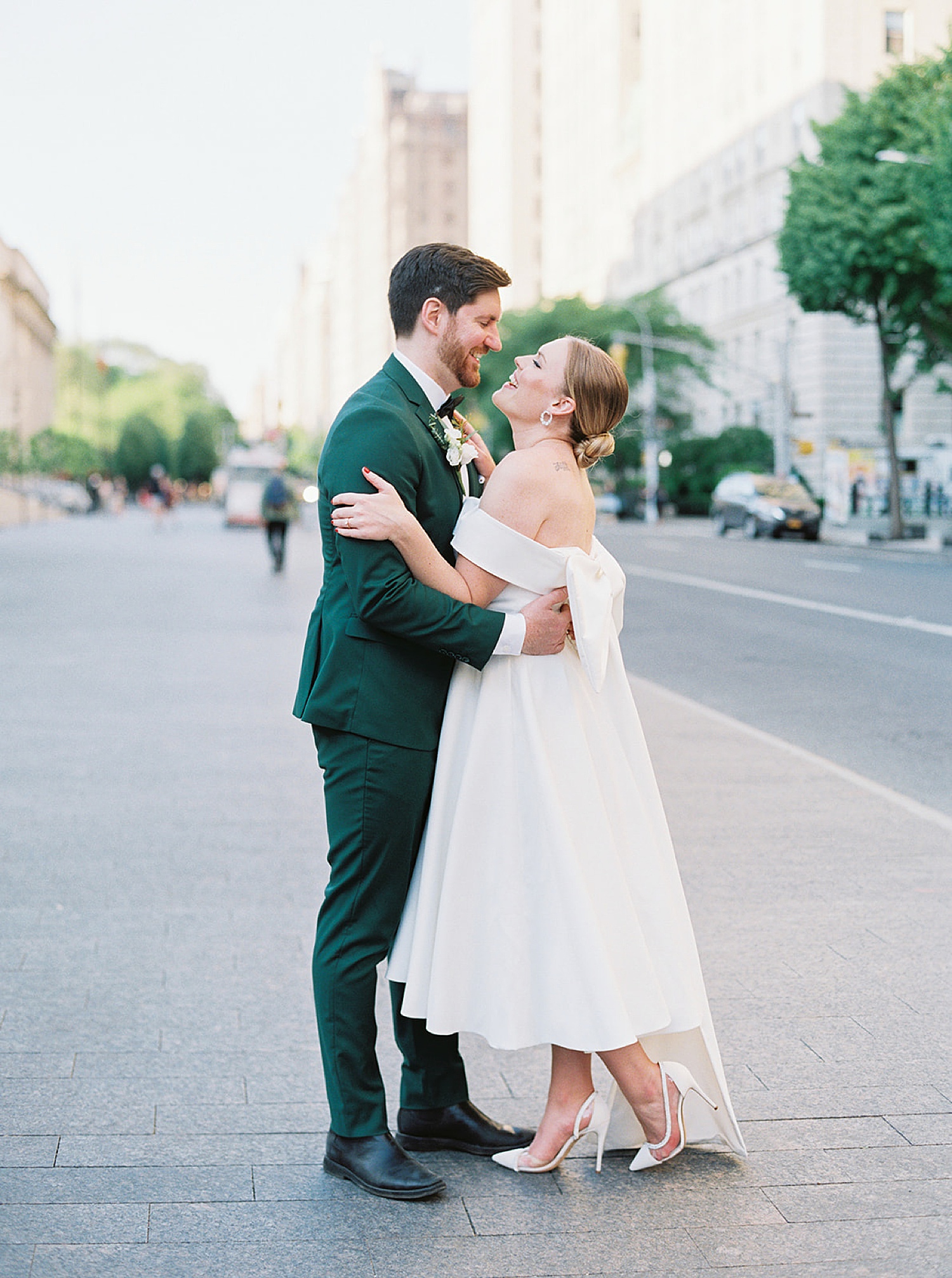newly married couple laughing while standing in the streets of New York City after elopement 