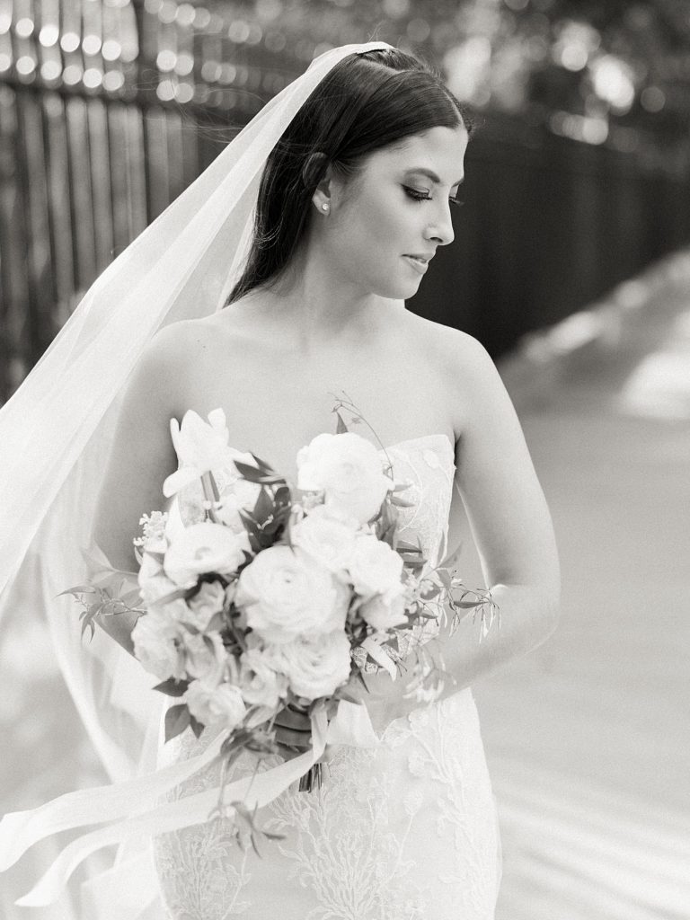 Black and white portrait of a bride looking down.