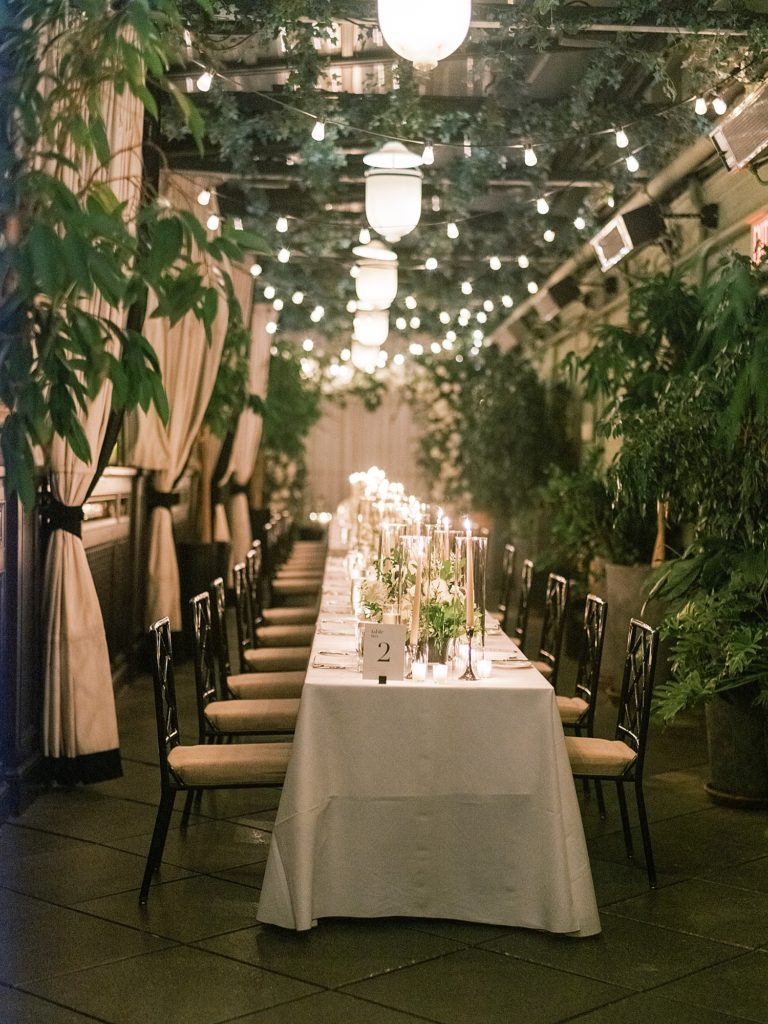 Long table under a lot of florals at a New York City Wedding.