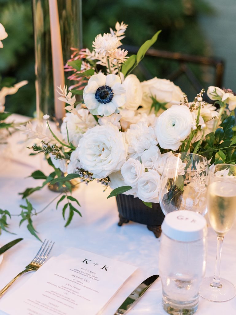 Detail image of white floral centerpieces at a wedding.