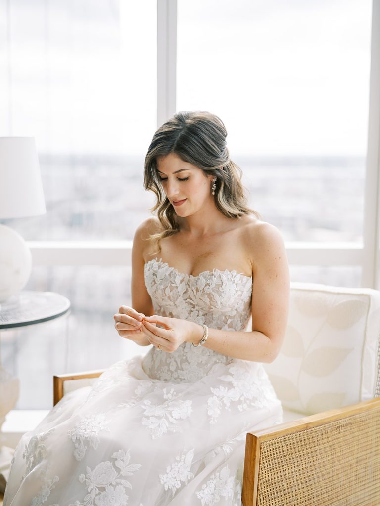 Bride sitting in a chair getting ready before her wedding.