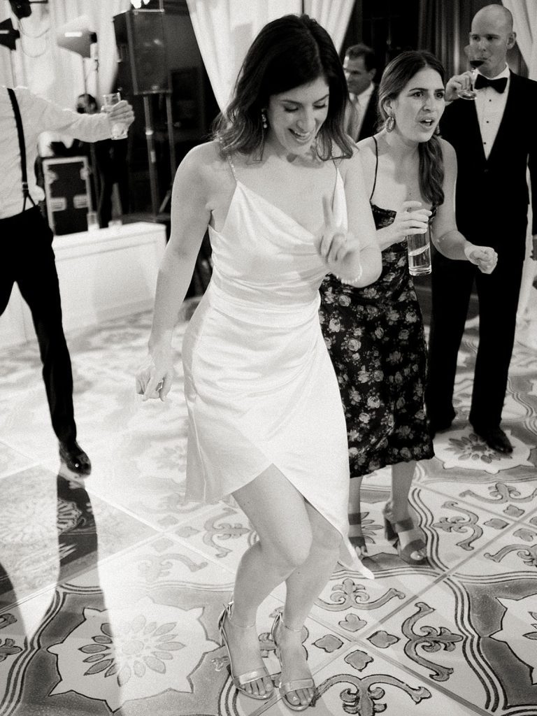 Black and white image of bride dancing.