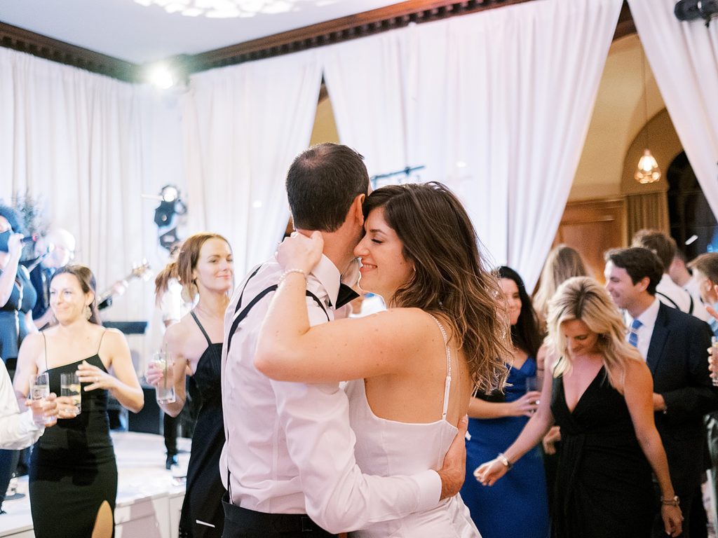Bride and groom embracing on the dance floor.