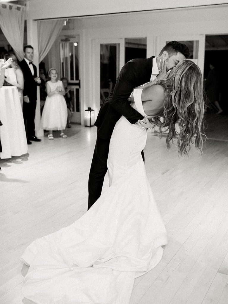 Newlyweds kissing on the dance floor of their editorial wedding reception in New York.