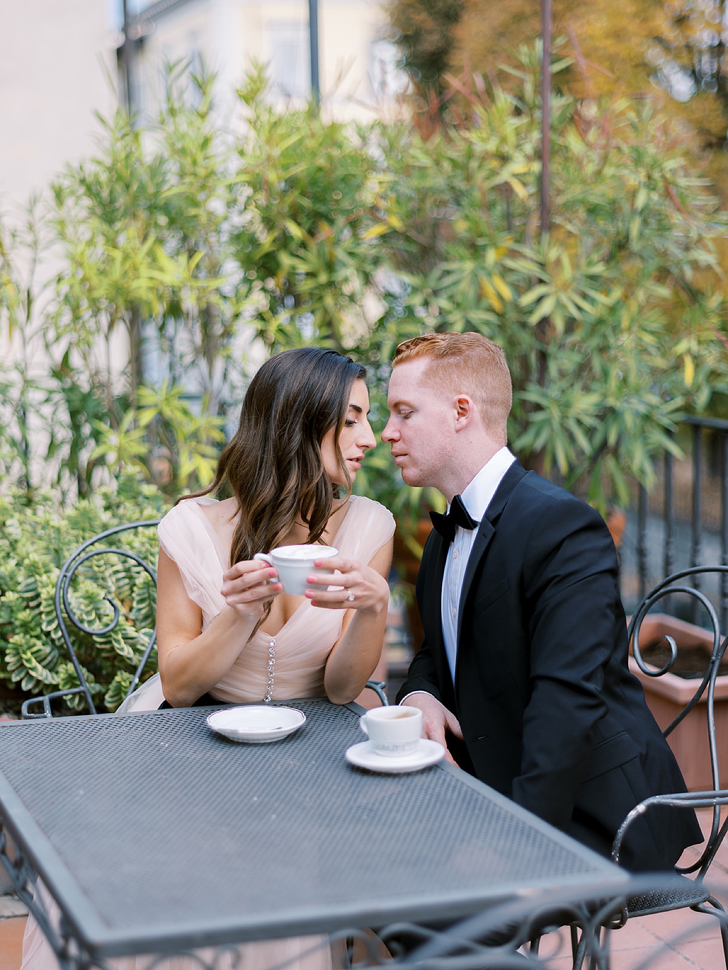 married couple sitting at Italian cafe with Italy wedding photographer