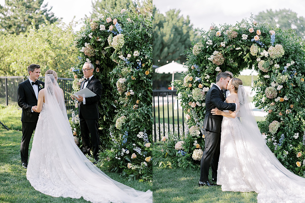 bride and groom share vows and kiss in front of flower arch at backyard wedding shot by sophie kaye photography