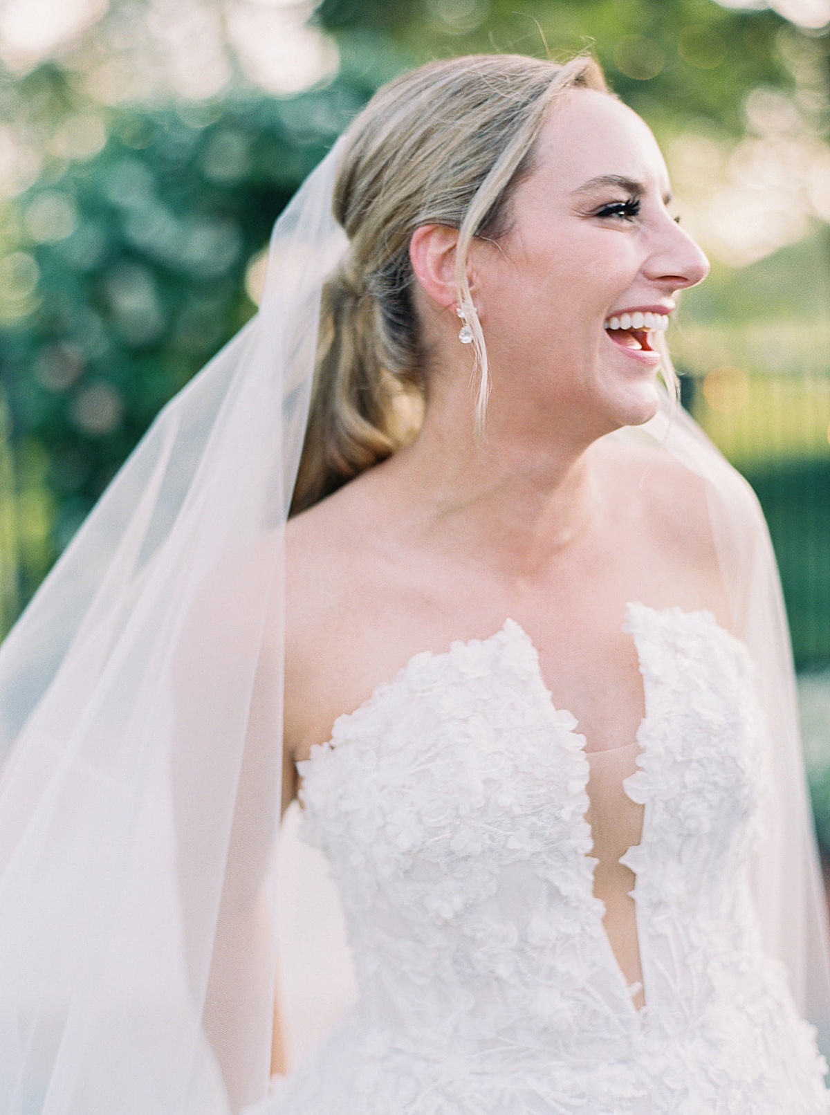 Bride close up with diamond earrings, embroidered embellished wedding gown, and veil shot by destination luxury photographer