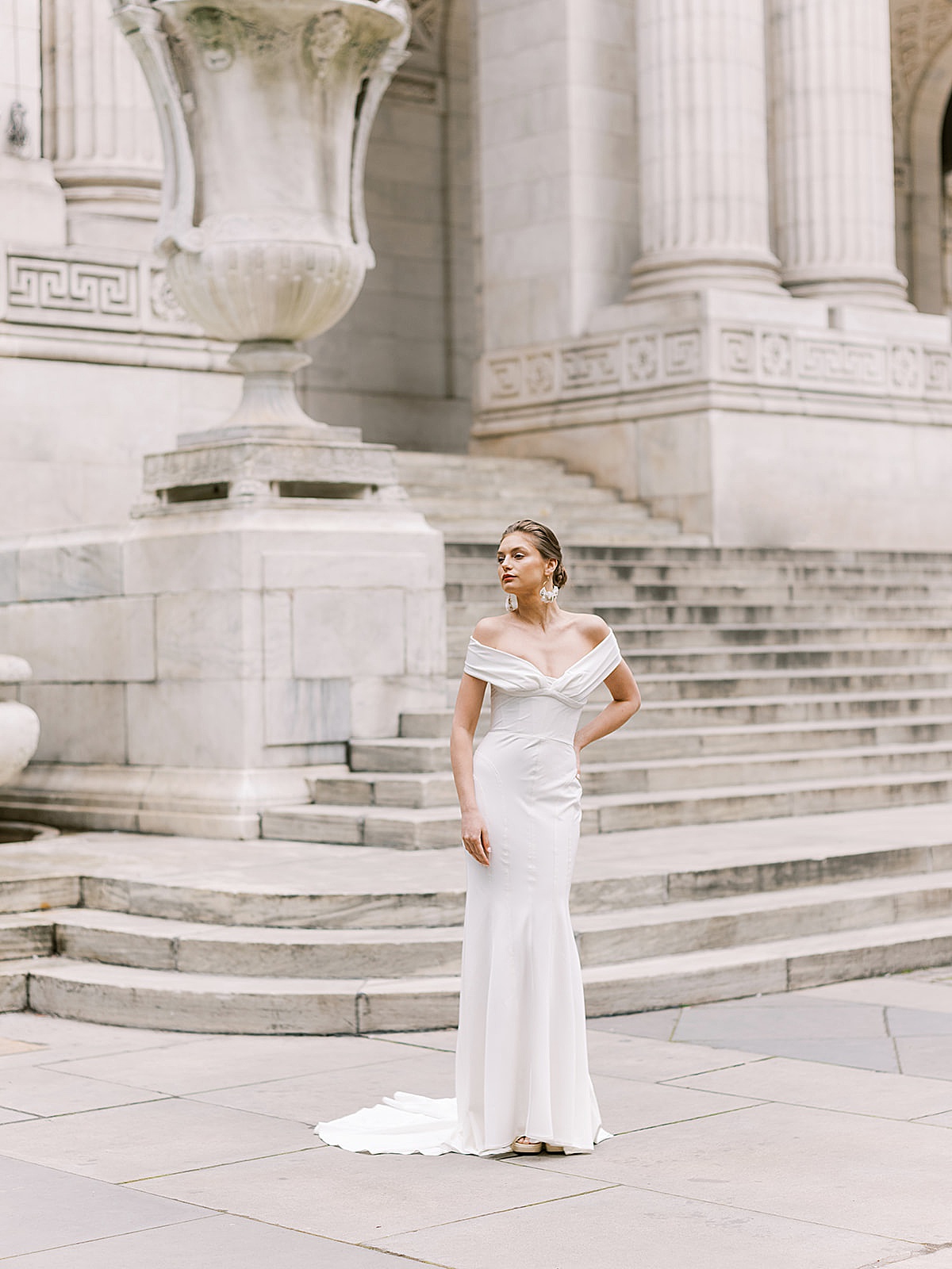 Bride in chic wedding gown poses on NY public library steps in Beccar couture lookbook photoshoot
