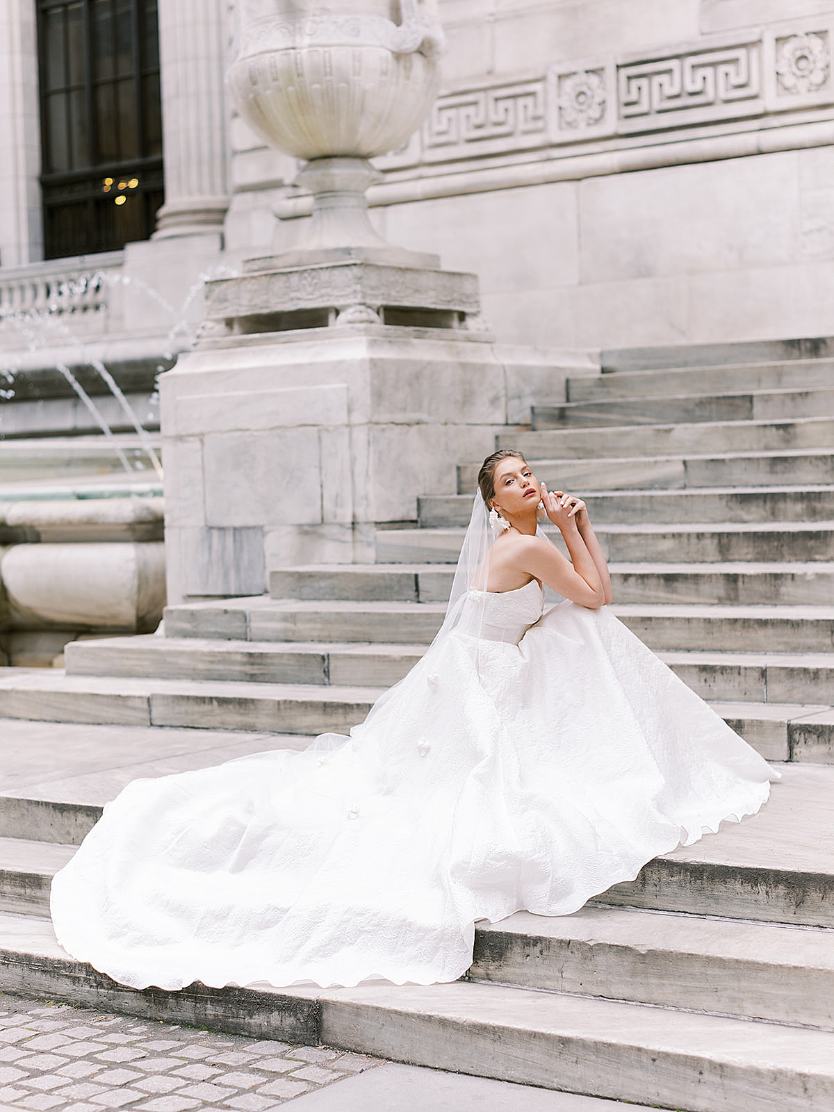 bride in ballgown wedding dress poses on NY landmark steps for Beccar couture lookbook shoot