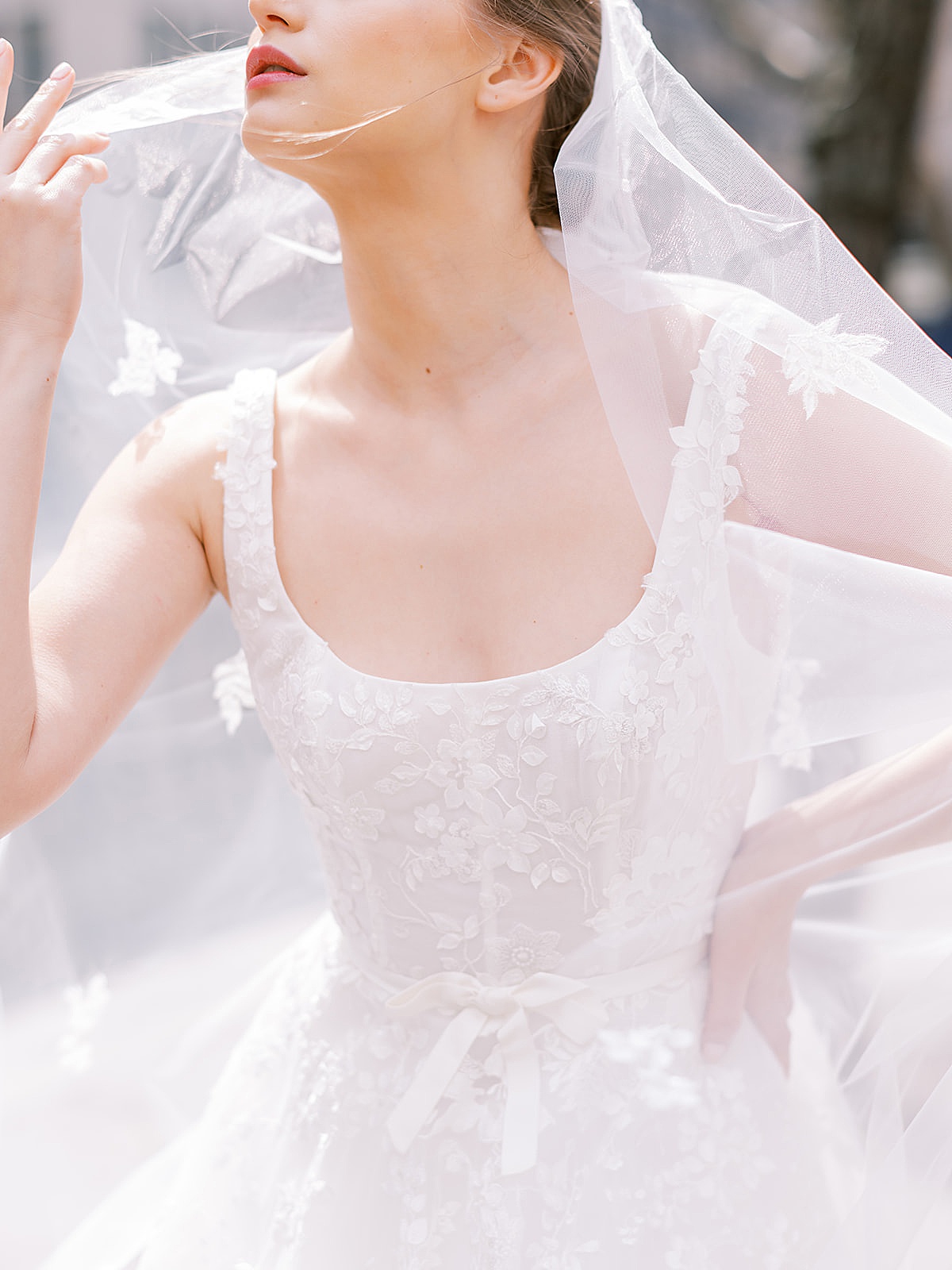 detail of woman in embellished wedding gown with lace trimmed veil shot by NYC Fashion Photographer