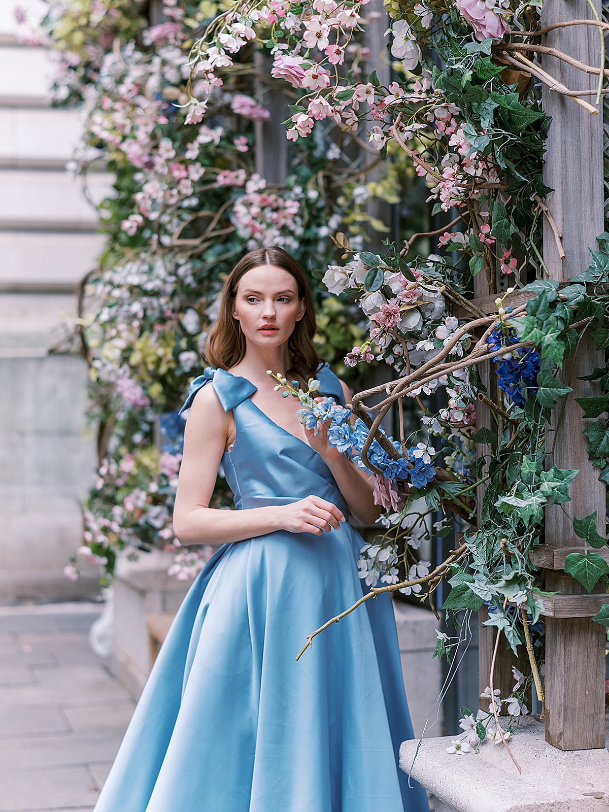 bride in nontraditional blue wedding gown poses in NYC photo shoot by Sophie Kaye Photography
