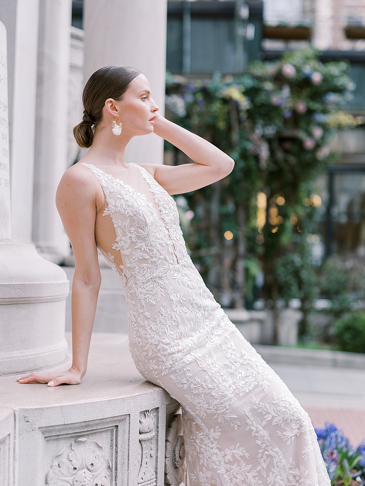 model in elegant embellished wedding gown with fitted silhouette and plunging neckline poses in NYC for shoot with Sophie Kaye Photography