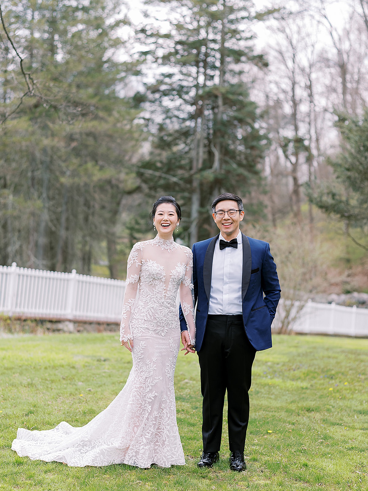Bride in couture gown and groom in blue evening jacket smile at Westchester Blue Hill Wedding