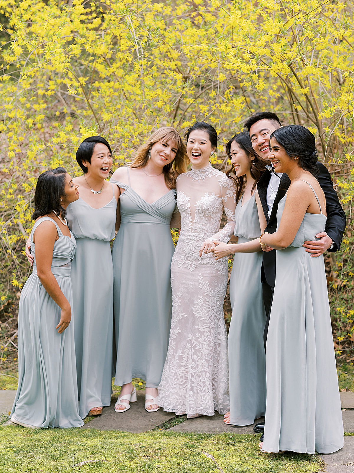 Bride and bridesmaids in pale blue gowns pose in front of yellow trees at Westchester Blue Hill Wedding