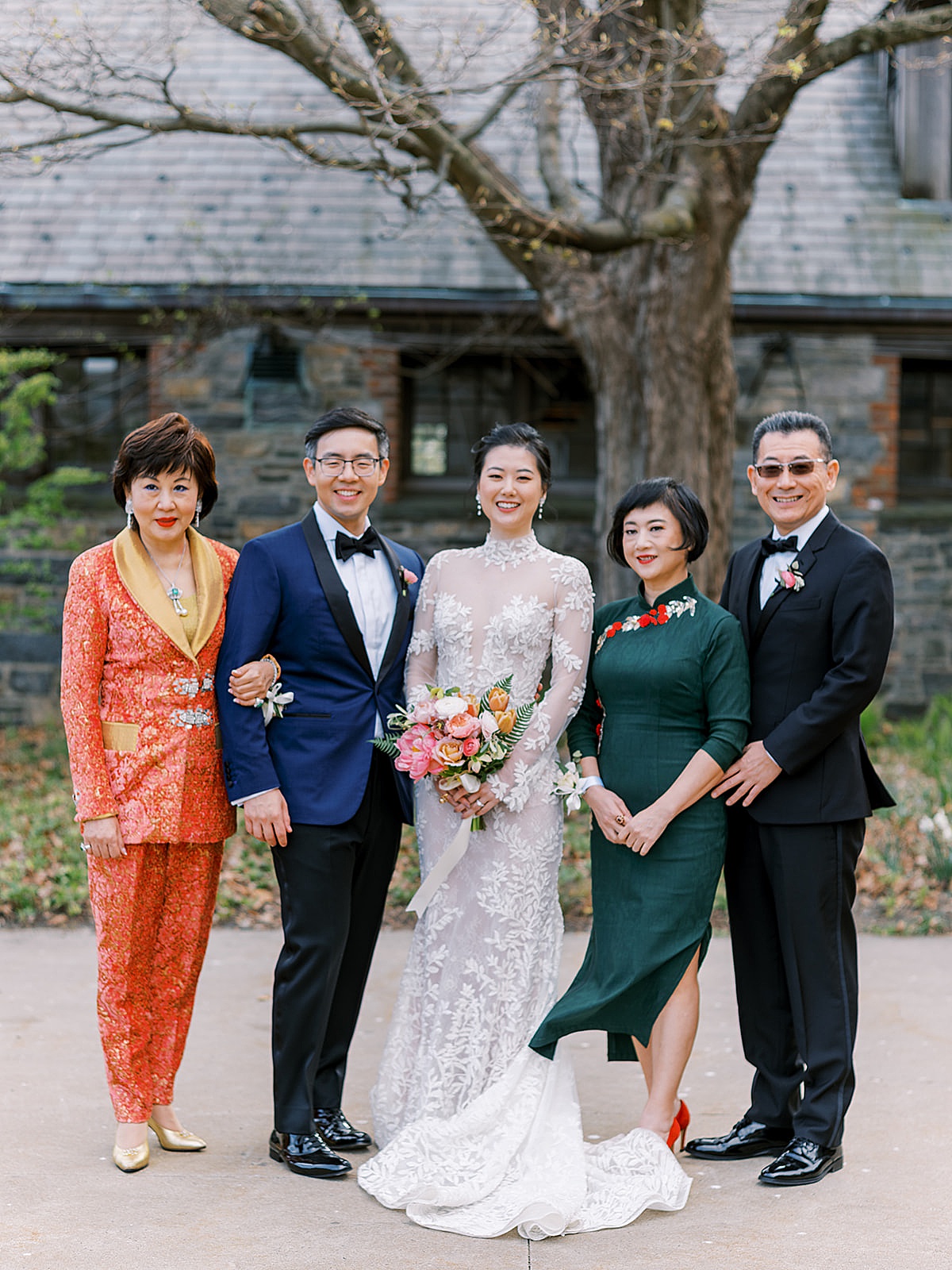 Bride and groom pose for family photo with parents at elegant wedding shot by Sophie Kaye Photography